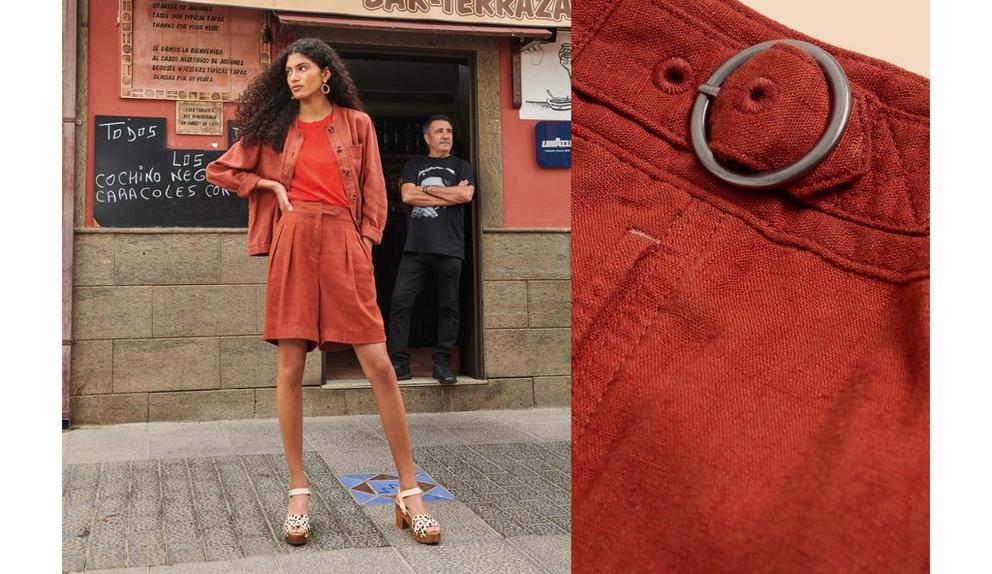 Woman wearing linen shorts standing in front of restaurant and closeup of belt